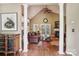 Open living room with vaulted ceilings, a cozy fireplace, and ample natural light at 7612 Maple Bluff Ln, Concord, NC 28025