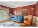 Stylish living room with a comfortable blue sofa, leather chair, and decorative accents at 7612 Maple Bluff Ln, Concord, NC 28025