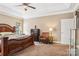 Main bedroom with large bed, ceiling fan, and large windows at 7612 Maple Bluff Ln, Concord, NC 28025