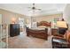 Spacious main bedroom with large bed, ceiling fan, and view to en-suite bathroom at 7612 Maple Bluff Ln, Concord, NC 28025