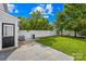 A spacious backyard featuring a well-maintained lawn, a white privacy fence, and a concrete patio for outdoor entertaining at 8614 Westhope St, Charlotte, NC 28216