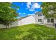 Lush, well-manicured backyard featuring green grass, a white privacy fence, and the rear of the home at 8614 Westhope St, Charlotte, NC 28216