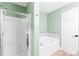 Bathroom with a separate glass shower and soaking tub with tile accents at 8614 Westhope St, Charlotte, NC 28216