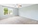Carpeted bedroom offers plenty of natural light from the large window at 8614 Westhope St, Charlotte, NC 28216