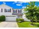 Charming two-story home with a well-maintained lawn and attached two-car garage at 8614 Westhope St, Charlotte, NC 28216