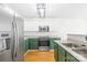 Modern kitchen featuring stainless steel appliances and green and white cabinets at 8614 Westhope St, Charlotte, NC 28216