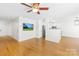 Open floor plan featuring hardwood floors, a mounted TV, and kitchen access at 8614 Westhope St, Charlotte, NC 28216