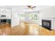 Bright and airy living space featuring hardwood floors, a fireplace, and an open floor plan at 8614 Westhope St, Charlotte, NC 28216
