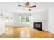 Comfortable living room area featuring a fireplace, hardwood floors, and large windows at 8614 Westhope St, Charlotte, NC 28216
