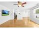 Spacious open-concept living area with hardwood floors, ceiling fan, and lots of natural light at 8614 Westhope St, Charlotte, NC 28216