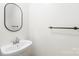 Modern half bath with a pedestal sink and contemporary fixtures at 8614 Westhope St, Charlotte, NC 28216