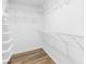 Walk-in closet featuring laminate floors and wire shelving units at 8614 Westhope St, Charlotte, NC 28216