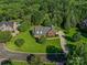 Aerial view of a home surrounded by lush greenery and showcasing its well-manicured landscape at 908 Haddonfield Dr, Fort Mill, SC 29708