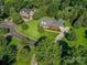 Beautiful brick home on a lush green lot with mature trees and a long driveway at 908 Haddonfield Dr, Fort Mill, SC 29708
