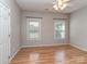 Bright bedroom with hardwood floors, white trim, and two sunny windows at 908 Haddonfield Dr, Fort Mill, SC 29708