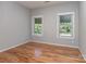 Bedroom featuring hardwood floors, neutral walls, and well-lit windows with pleasant views at 908 Haddonfield Dr, Fort Mill, SC 29708