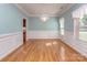 Dining room with hardwood floors, elegant chandelier, and views of the outside greenery through large windows at 908 Haddonfield Dr, Fort Mill, SC 29708