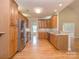 Spacious kitchen with stainless steel appliances, custom cabinets, granite countertops, and hardwood floors at 908 Haddonfield Dr, Fort Mill, SC 29708