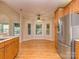 Bright breakfast nook with large windows, hardwood floors, and stainless steel refrigerator at 908 Haddonfield Dr, Fort Mill, SC 29708