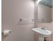 Clean powder room with a pedestal sink and decorative mirror at 908 Haddonfield Dr, Fort Mill, SC 29708