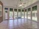 Bright sunroom with tile flooring and multiple windows offering scenic outdoor views at 908 Haddonfield Dr, Fort Mill, SC 29708