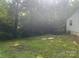 Backyard featuring a lush lawn and surrounding trees, offering a serene outdoor space at 9314 Seymour Ln, Davidson, NC 28036