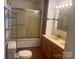 Bathroom with double sinks, vanity and shower with gold enclosure at 9314 Seymour Ln, Davidson, NC 28036
