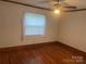 Bedroom with hardwood floors, neutral walls, ceiling fan and bright windows at 9314 Seymour Ln, Davidson, NC 28036