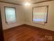 Bedroom featuring hardwood floors and natural light from two windows, creating a comfortable space at 9314 Seymour Ln, Davidson, NC 28036