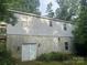 The exterior is comprised of siding and cinder block, situated among lush greenery at 9314 Seymour Ln, Davidson, NC 28036