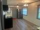 View of the kitchen features wood-look flooring, stainless steel appliances, and painted cabinets at 9314 Seymour Ln, Davidson, NC 28036