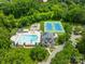 Aerial shot of neighborhood pool and amenity center with tennis courts, a playground, and a slide at 9514 Hayenridge Ct, Huntersville, NC 28078