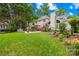Lush backyard featuring a well-kept lawn, patio with outdoor dining, and mature trees at 9514 Hayenridge Ct, Huntersville, NC 28078