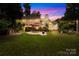 Expansive backyard with a patio, outdoor seating, well-maintained lawn, and manicured landscaping at 9514 Hayenridge Ct, Huntersville, NC 28078