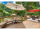 Outdoor deck area with ample seating, including couches and benches, under shaded umbrellas at 9514 Hayenridge Ct, Huntersville, NC 28078