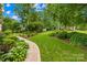 Beautifully landscaped front yard with lush greenery, walkway, and mature trees, perfect for enjoying the outdoors at 9514 Hayenridge Ct, Huntersville, NC 28078