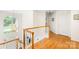 Hallway with gleaming wood floors, a window, and white trim at 9514 Hayenridge Ct, Huntersville, NC 28078