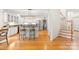 Bright kitchen with white cabinets, granite countertops, stainless steel appliances, and a view of the stairs at 9514 Hayenridge Ct, Huntersville, NC 28078