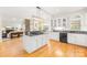 Bright kitchen with white cabinets, granite countertops and a large island with gas cooktop at 9514 Hayenridge Ct, Huntersville, NC 28078