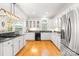 Spacious kitchen featuring white cabinets, granite countertops, stainless steel appliances, and hardwood floors at 9514 Hayenridge Ct, Huntersville, NC 28078