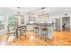 Bright kitchen with white cabinets, granite countertops, stainless steel appliances, and breakfast table at 9514 Hayenridge Ct, Huntersville, NC 28078