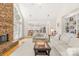 Spacious living room with stone fireplace, hardwood floors and view into the kitchen at 9514 Hayenridge Ct, Huntersville, NC 28078