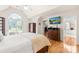 Bright main bedroom featuring gleaming hardwood floors, an arched window, and neutral walls at 9514 Hayenridge Ct, Huntersville, NC 28078