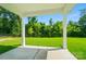 Enjoy outdoor living on this backyard patio with a view of the green lawn and surrounding trees at 9846 Quercus Ln, Huntersville, NC 28078