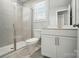 Bathroom featuring a glass-enclosed shower, toilet, and a vanity with sleek white cabinetry at 9846 Quercus Ln, Huntersville, NC 28078