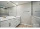 Modern bathroom featuring a double vanity, sleek cabinetry, and a tiled walk-in shower at 9846 Quercus Ln, Huntersville, NC 28078