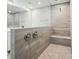 Modern shower with a glass enclosure, rainfall showerhead, and gray tiling at 9846 Quercus Ln, Huntersville, NC 28078