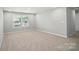 Bright, carpeted bedroom offers a serene retreat with natural light and a calm atmosphere at 9846 Quercus Ln, Huntersville, NC 28078