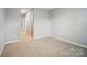 Neutral bedroom with carpeted floors, ample natural light, and an open doorway at 9846 Quercus Ln, Huntersville, NC 28078