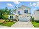 Charming two-story home featuring white siding, stone accents, manicured landscaping, and an attached two-car garage at 9846 Quercus Ln, Huntersville, NC 28078